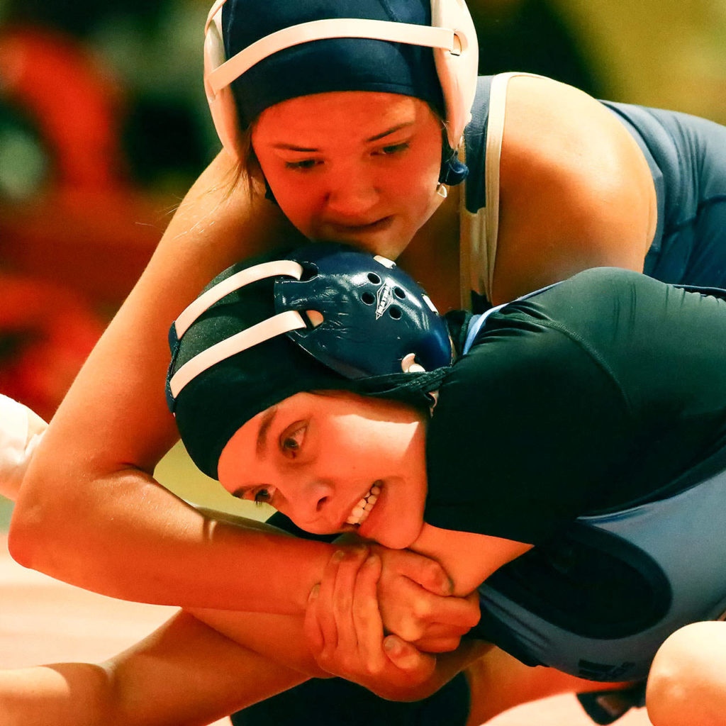 Arlington’s Tailer Cochran (top) work to pin Meadowdale’s Farrah Padilla during a girls wrestling scramble on Jan. 8, 2020, at Snohomish High School. (Kevin Clark / The Herald)
