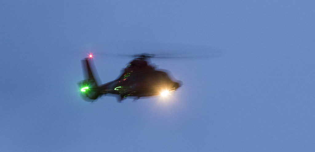 Divers and other rescue personnel search for a man who was last seen swimming to shore after his inflatable boat capsized off the beach north of the Mukilteo ferry Wednesday. (Andy Bronson / The Herald)
