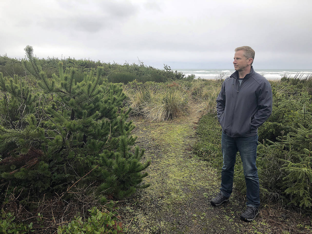 Jeff Bryner gazes at the lot that a Facebook subsidiary bought to convert it into a landing site for a trans-oceanic cable in Tierra Del Mar, Oregon. (AP Photo/Andrew Selsky)