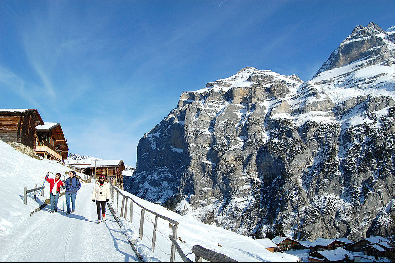 Travelers walk down a path in the small village of Gimmelwald in Switzerland. (Rick Steves’ Europe)