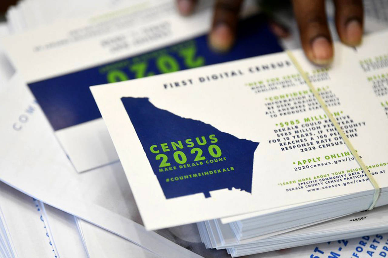 In this August 2019 photo, a worker gets ready to pass out instructions on how to fill out the 2020 census during a town hall meeting in Lithonia, Georgia. (AP Photo/John Amis. file)