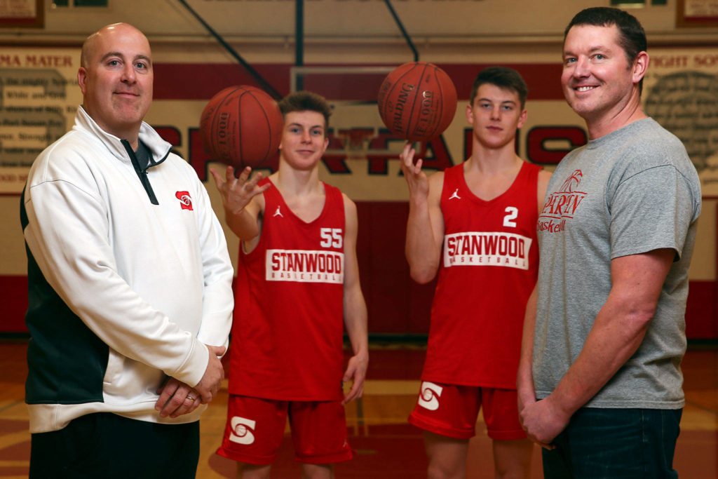 Harlan Roberson (left-right) with son Cort Roberson and Jake Cleary with his father Chad Cleary. (Kevin Clark / The Herald)
