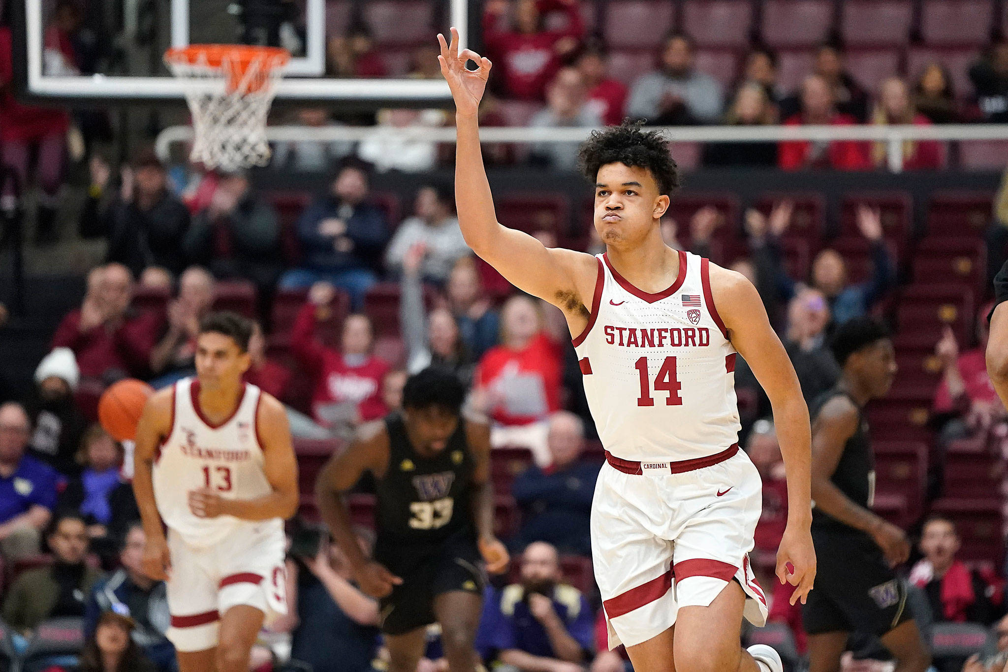 Stanford forward Spencer Jones (14) reacts after making a 3-pointer during the first half of a game against Washington on Thursday in Stanford, Calif. (AP Photo/Tony Avelar)
