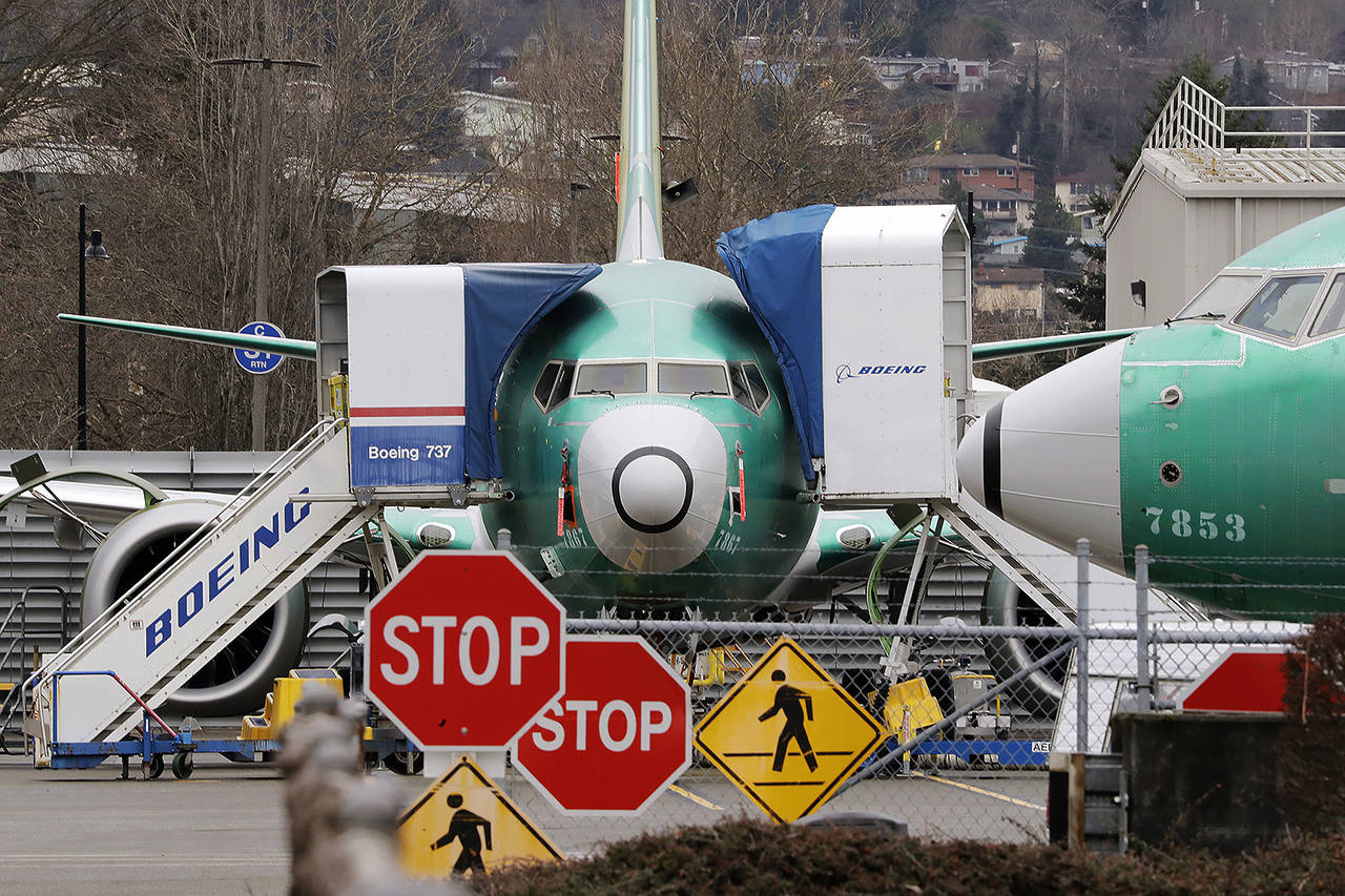 In this Dec. 16, 2019 photo, a Boeing 737 Max jets sit parked in Renton. (AP Photo/Elaine Thompson, File)