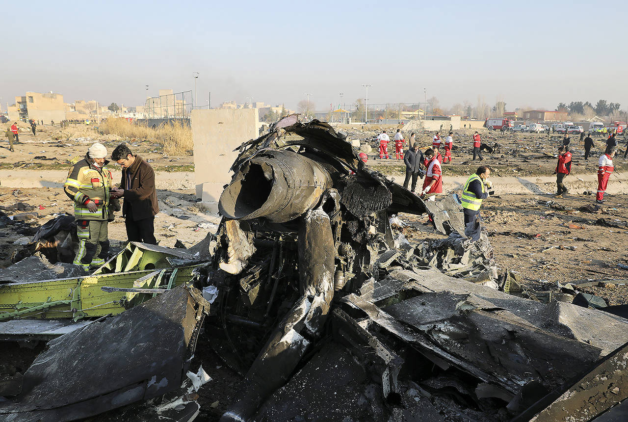 In this Wednesday photo, debris can be seen at the scene where a Ukrainian plane crashed in Shahedshahr southwest of the capital Tehran, Iran. (AP Photo/Ebrahim Noroozi)