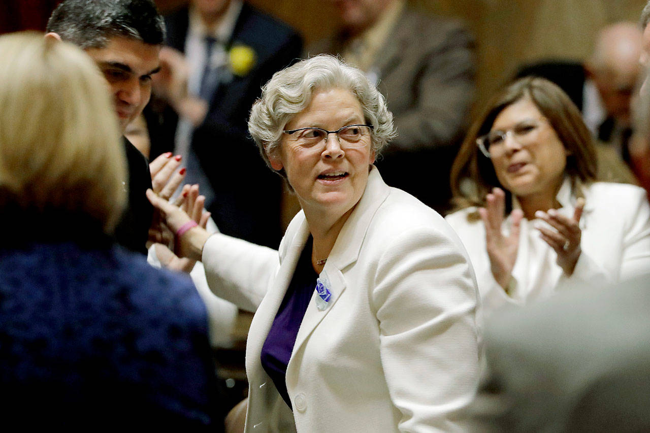House Speaker Laurie Jinkins, D-Tacoma, is greeted on the floor of the House as she arrives to be sworn in Monday, the first day of the 2020 session of the Washington Legislature, at the Capitol in Olympia. (AP Photo/Ted S. Warren)