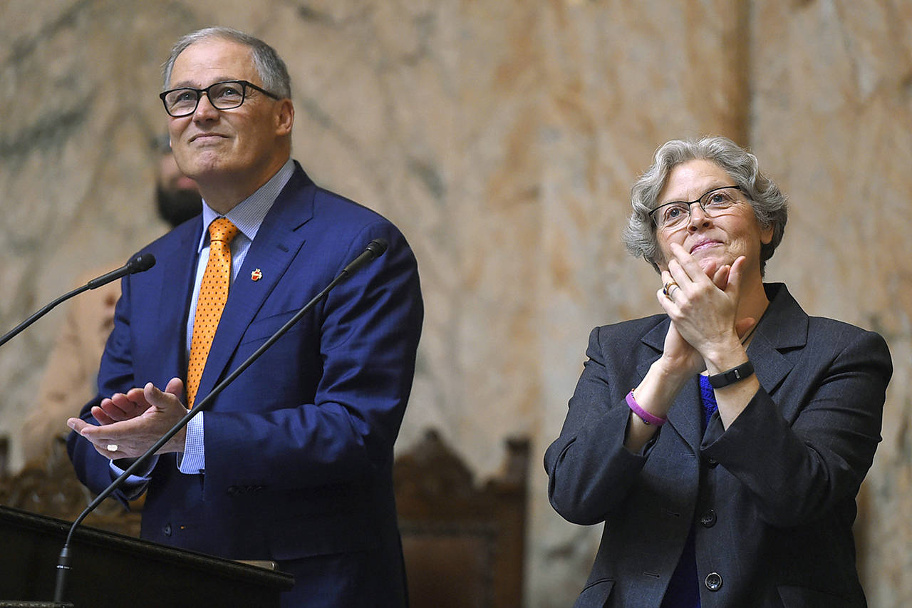 Washington Gov. Jay Inslee, along with new Speaker of the House Laurie Jenkins, applaud gallery introductions before the governor’s annual State of the State to a joint session of the state Legislature in the House Chambers in Olympia on Tuesday. (Steve Bloom/The Olympian via AP)