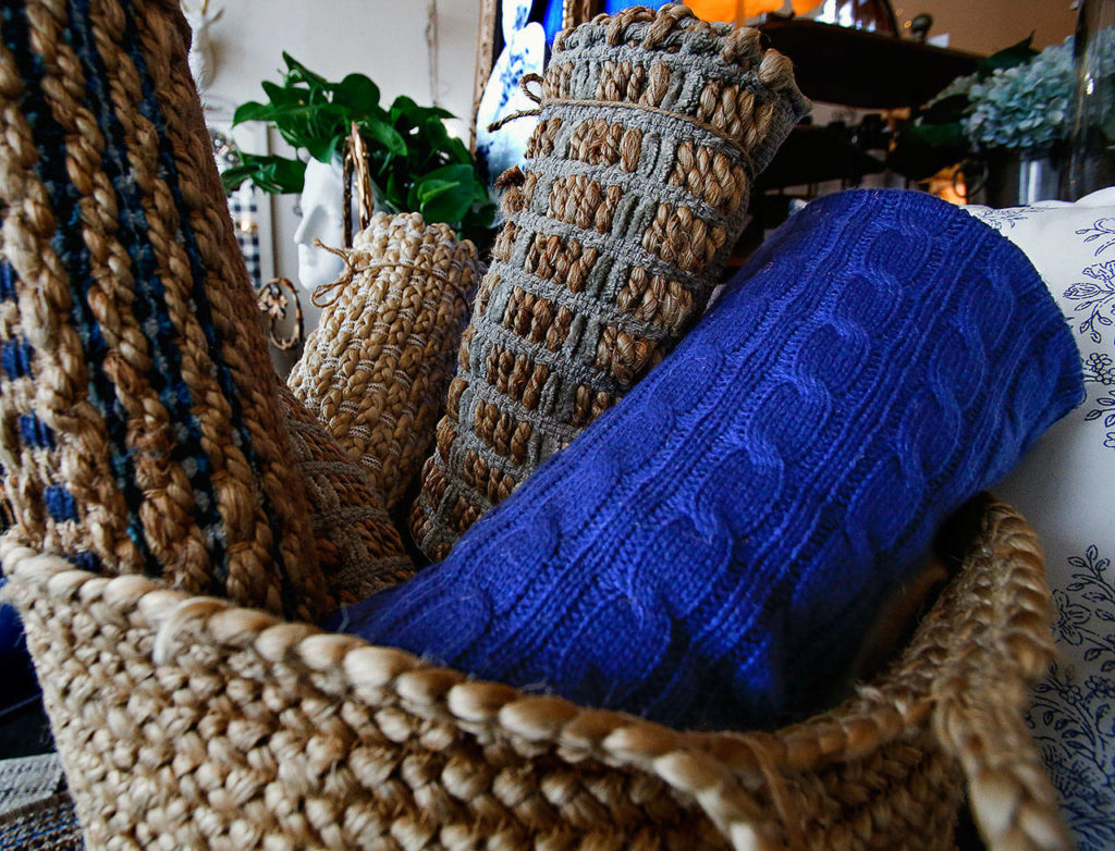 At one side of DuByne’s display, very nice rug in the Pantone classic blue pokes its head from a basketful of shy folk. (Dan Bates / The Herald)
