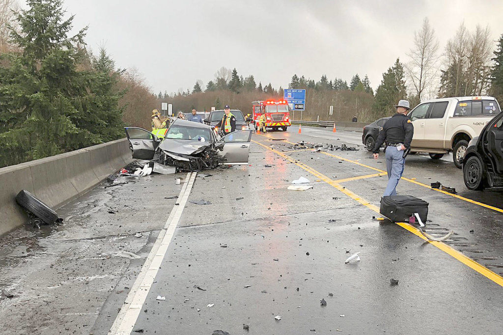 First responders inspect the wreckage of a three-car crash Sunday afternoon on U.S. 2 near Highway 9 and Bickford Avenue in Snohomish. (Washington State Patrol)
