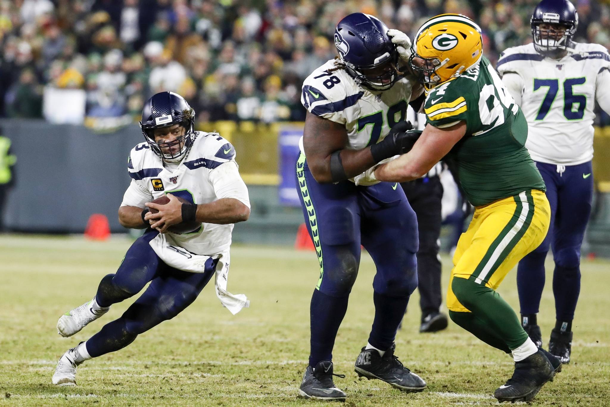 Seattle Seahawks quarterback Russell Wilson runs for a first down during the second half Sunday against Green Bay (AP Photo/Matt Ludtke)