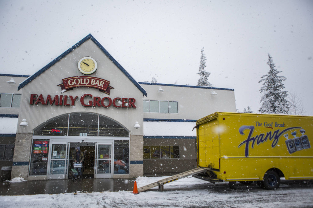 A Franz truck makes a delivery to the Gold Bar Family Grocer on Monday in Gold Bar. Eastbound access on U.S. 2 was limited to residents of Index and required a State Patrol escort. (Olivia Vanni / The Herald)
