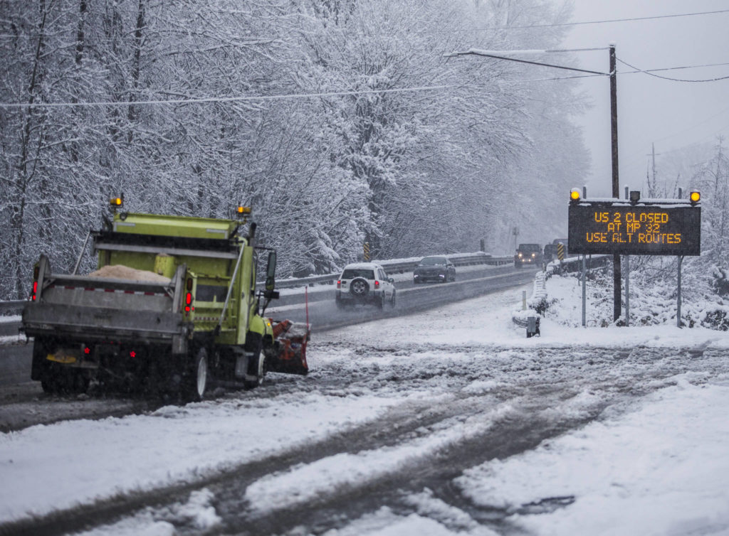 A snow plow waits Monday at the side of U.S. 2 in Monroe. (Olivia Vanni / The Herald)
