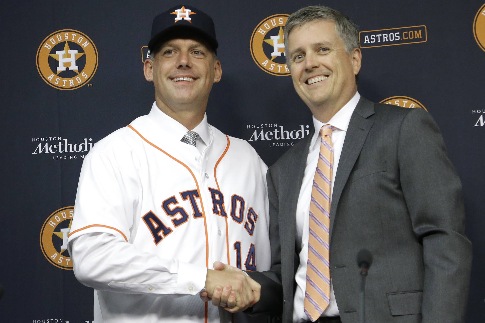 In this Sept. 29, 2014, file photo, Houston Astros general manager Jeff Luhnow (right) and A.J. Hinch pose after Hinch was introduced as the team’s manager. Hinch and Luhnow were fired Monday for their roles in the team’s sign-stealing scheme. (AP Photo/Pat Sullivan, File)