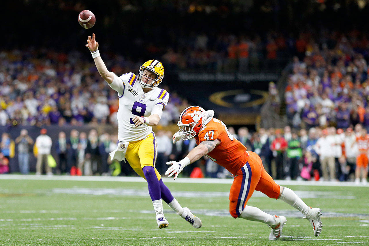 LSU quarterback Joe Burrow passes under pressure from Clemson linebacker James Skalski during the College Football Playoff national championship game Monday in New Orleans. (AP Photo/Gerald Herbert)