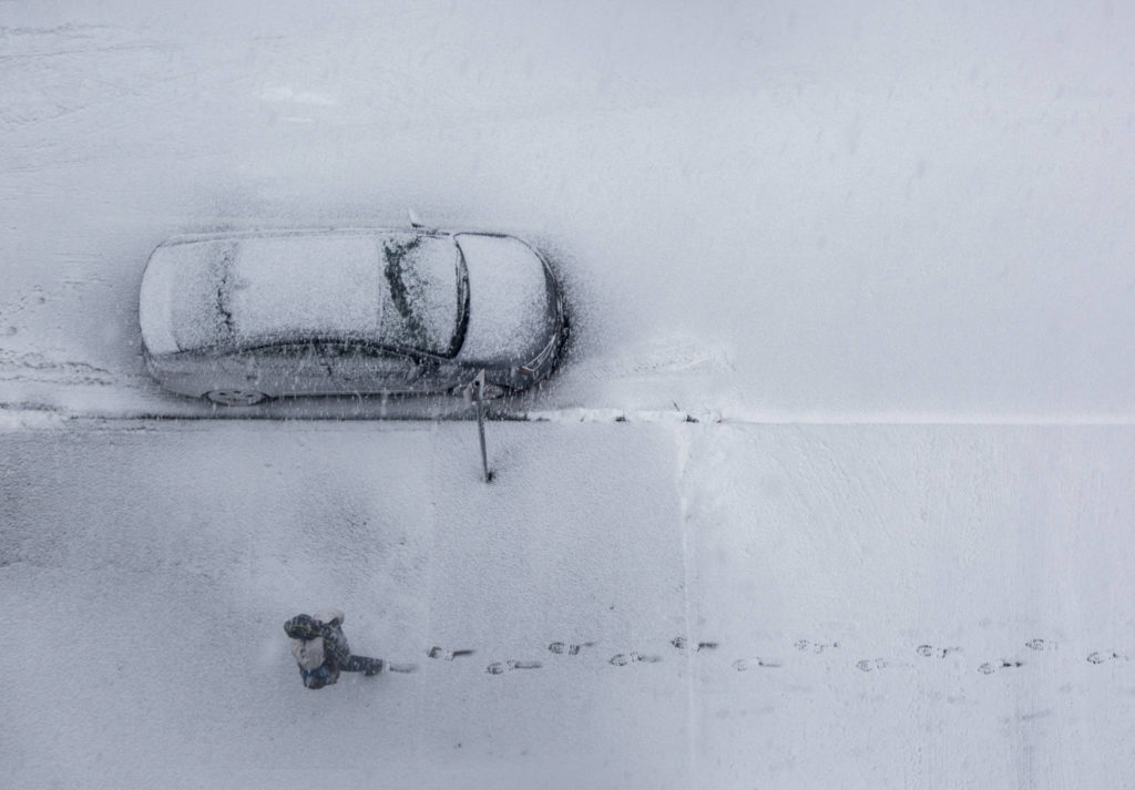 A man walks through fresh snow in downtown Everett on Wednesday. (Olivia Vanni / The Herald)
