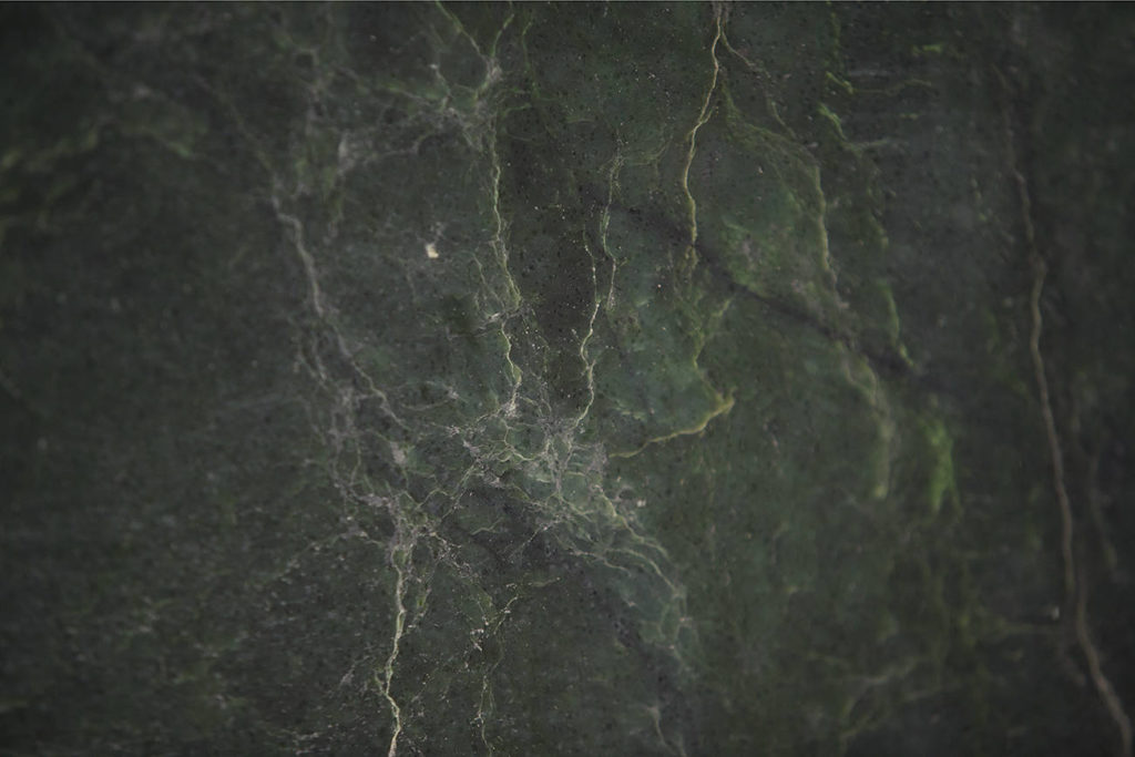 The dark-green jade boulder found by prospectors Ed Moslee and Jason Henry is nephrite jade, commonly used in carvings and furniture such as coffee tables. (Andy Bronson / The Herald)
