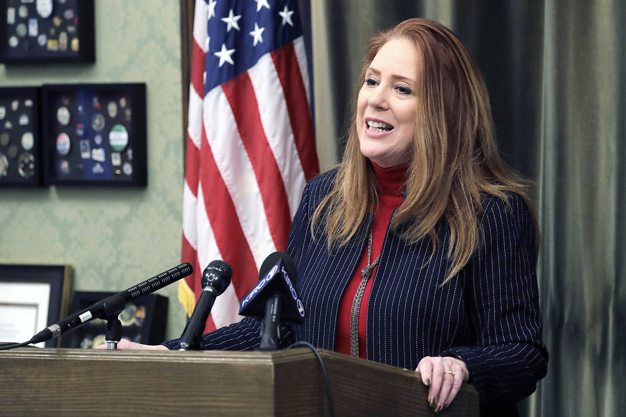 Washington Secretary of State Kim Wyman talks to reporters in her office Wednesday at the Capitol in Olympia. (AP Photo/Ted S. Warren)