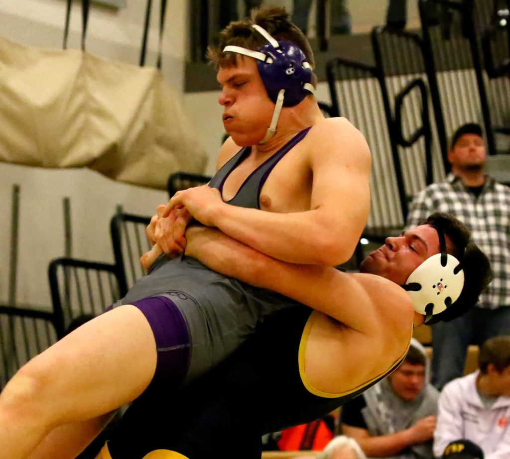 Lake Stevens’ Jacob Vincent is lifted by Tahoma’s Levi Kovacs in a 220-pound match at the Viking Invite on Saturday at Cavalero Mid High School in Lake Stevens. (Kevin Clark / The Herald)
