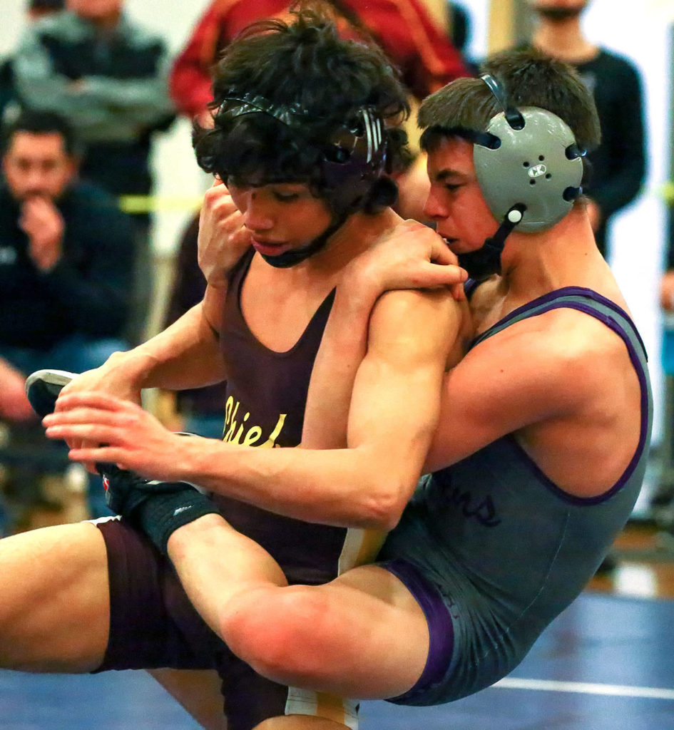 Moses Lake’s Jonathan Tanguma works to get free from Lake Stevens’ Jake Hubby Jr. in a 113-pound match at the Viking Invite on Saturday at Cavalero Mid High School in Lake Stevens. (Kevin Clark / The Herald)
