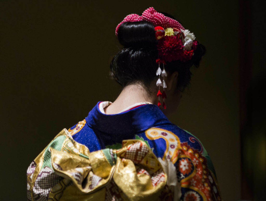 Kotoko Miyamae waits to have her makeup touched up on Jan. 24 in Everett. (Olivia Vanni / The Herald)
