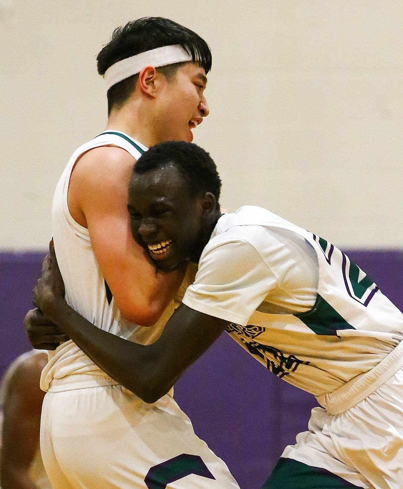 Edmonds-Woodway’s Bryan Bunyatipanon (left) celebrates with Mutdung Bol after Bunyatipanon made a game-winning 3-pointer to defeat Marysville Getchell on Friday evening at Edmonds-Woodway High School. (Kevin Clark / The Herald)