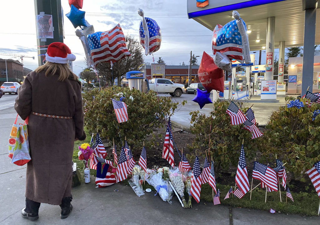 Flags and balloons are seen at a memorial for Samiu Bloomfield at the corner of Broadway and Everett Ave. on Monday in Everett. (Sue Misao / The Herald)
