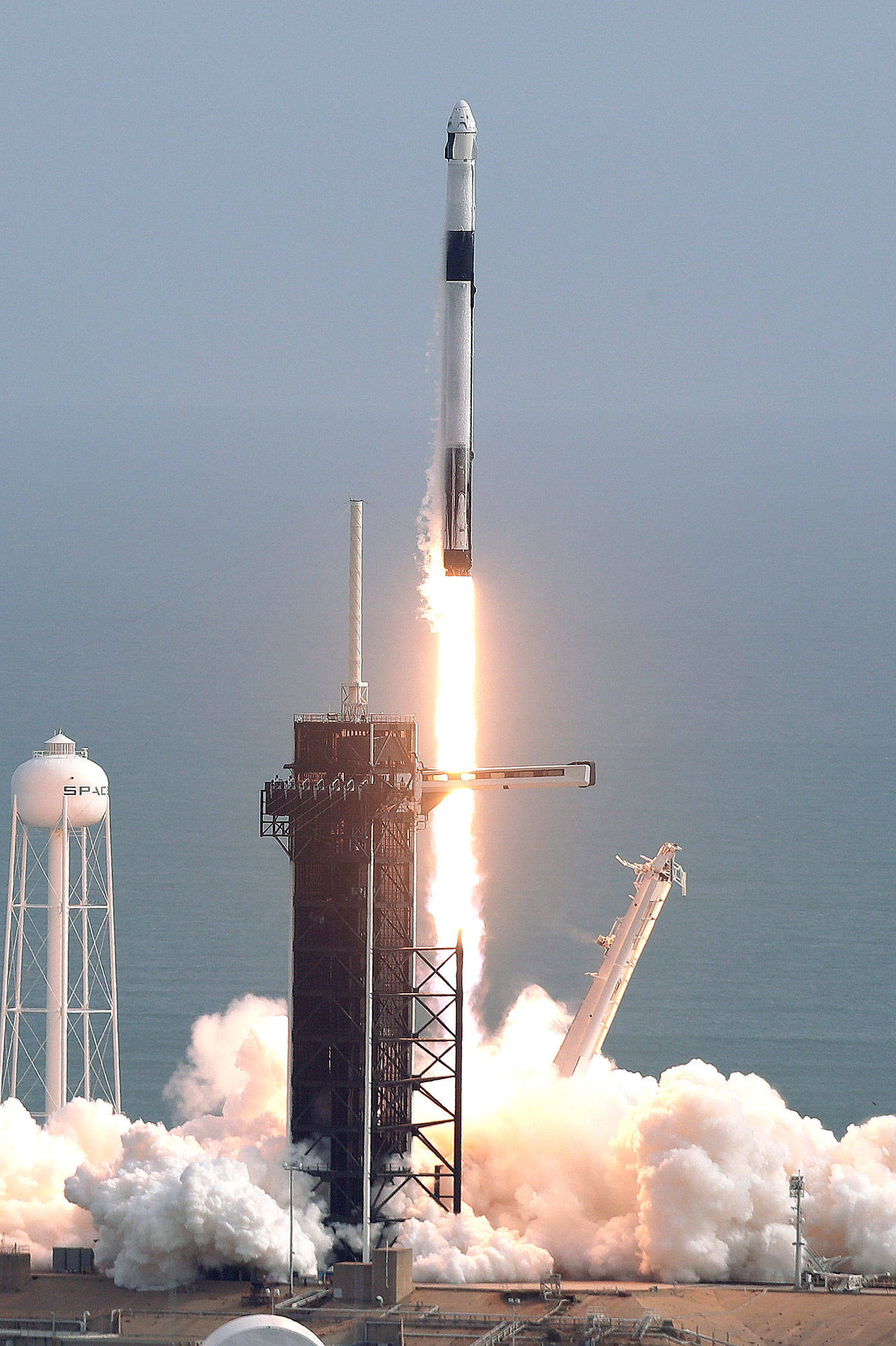 A Falcon 9 SpaceX rocket lifts off from pad 39A Sunday at the Kennedy Space Center in Cape Canaveral, Florida, during a test flight to demonstrate the capsule’s emergency escape system. (AP Photo/John Raoux)
