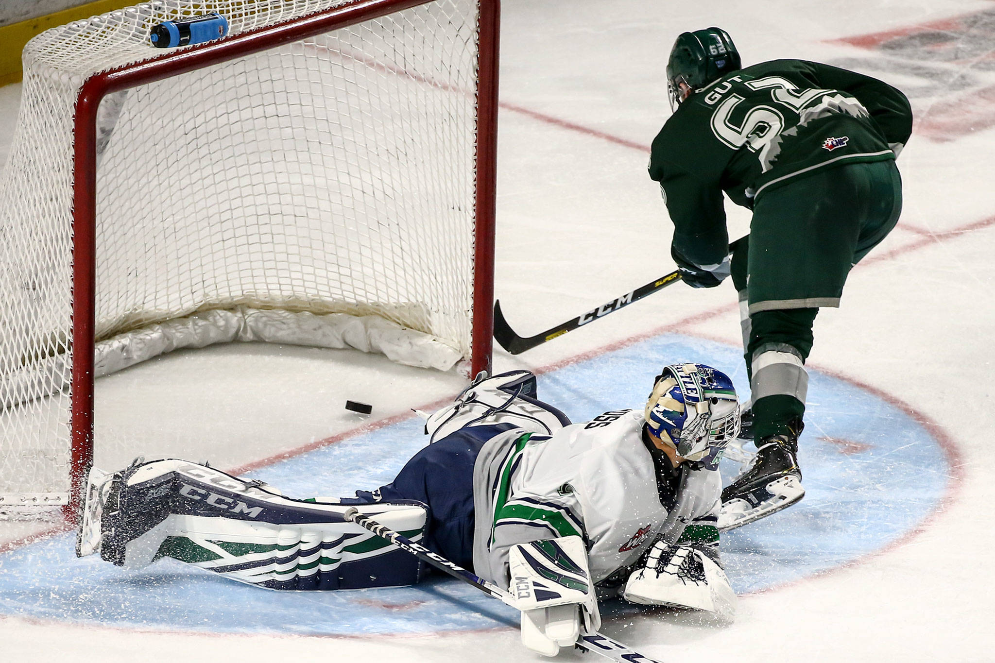 Everett’s Michal Gut scores a goal past Seattle goaltender Roddy Ross in the third period Sunday evening at the ShoWare Center in Kent. (Kevin Clark / The Herald)
