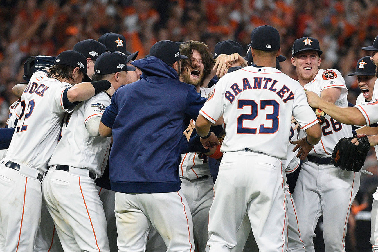 Houston Astros starting pitcher Gerrit Cole, center, celebrates with teammates after their win in Game 5 of a baseball American League Division Series against the Tampa Bay Rays in Houston, Thursday, Oct. 10, 2019. Houston won 6-1, and advances to the AL Championship Series. (AP Photo/Eric Christian Smith)