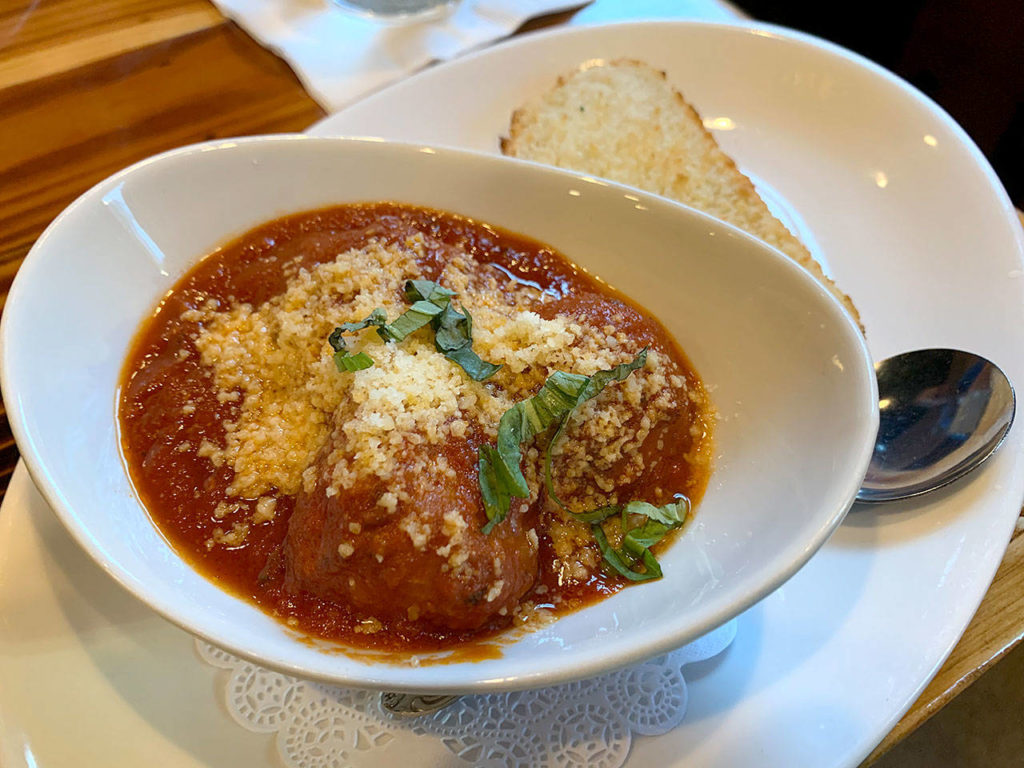 The meatballs at The Brick Oven Pizza Lounge are made of pork and veal and served with parmesan cheese, pomodoro sauce and garlic bread. (Evan Thompson / The Herald)

