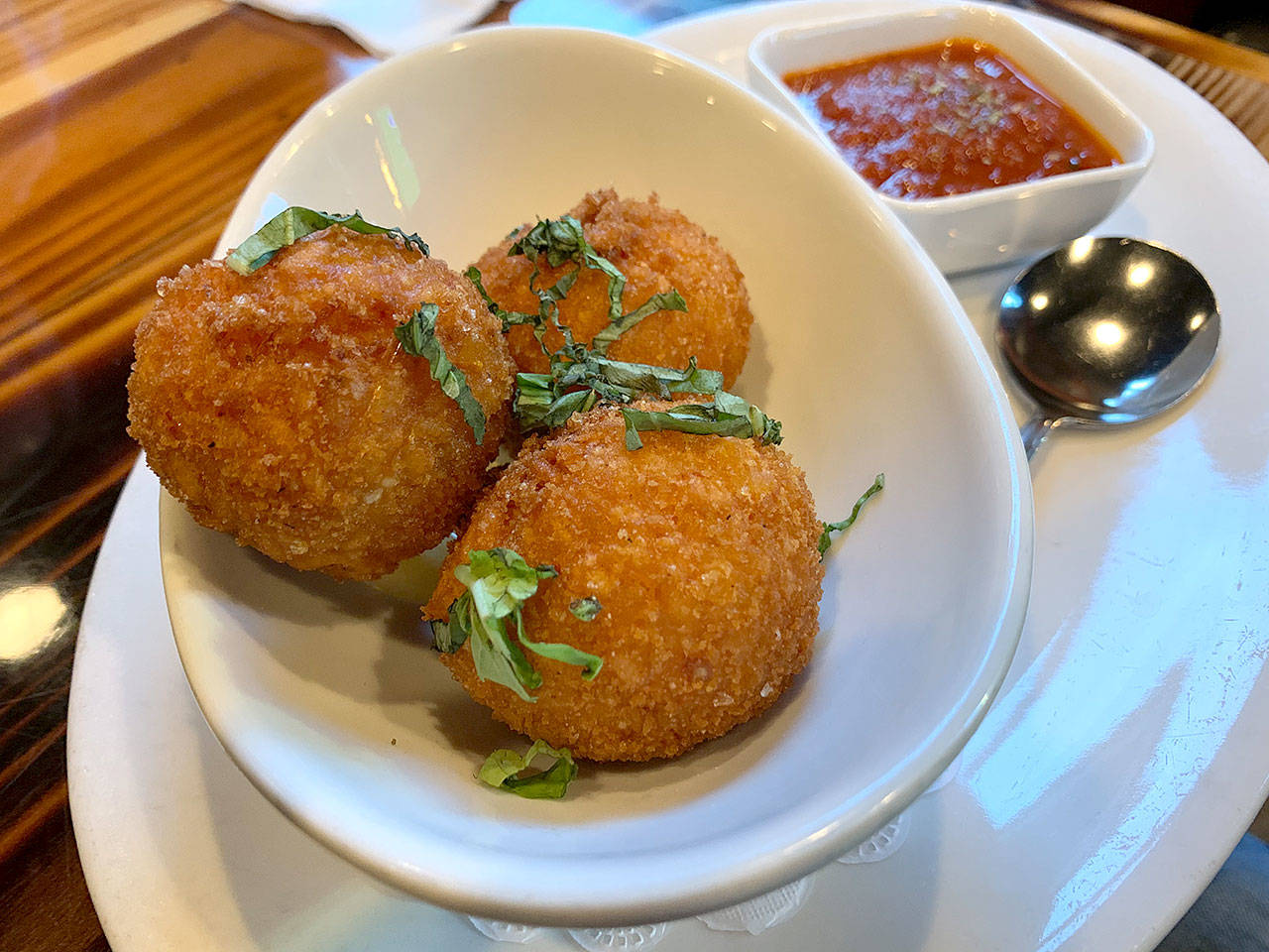 Arancini are rice balls stuffed with arborio rice, mozzarella cheese, parsley and parmesan cheese, then fried. (Evan Thompson / The Herald)