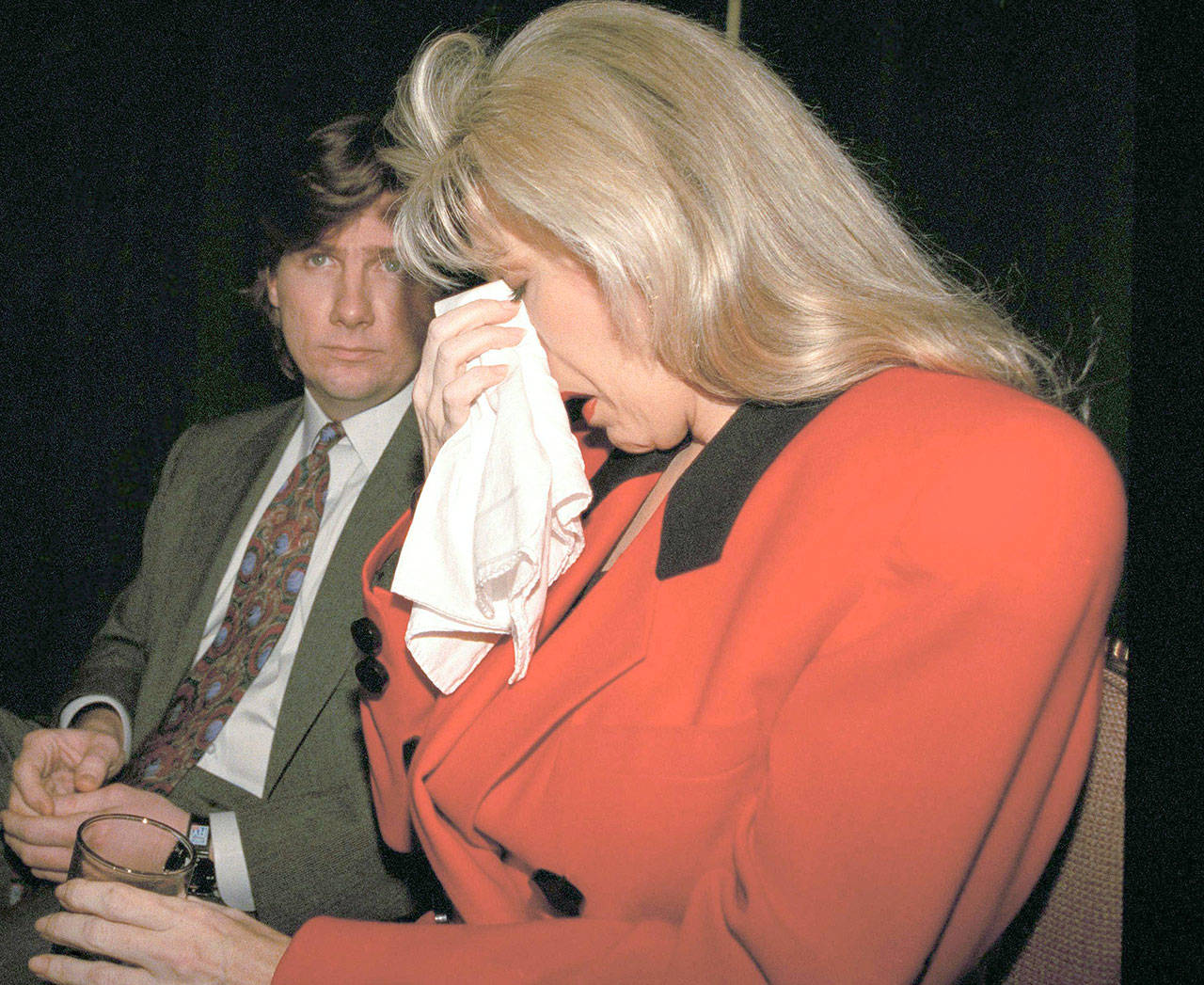 Gennifer Flowers, who said she had a 12-year affair with Democratic presidential hopeful Bill Clinton, dabs her eyes while listening to an audiotape of what she said was Clinton talking to her on the phone during a news conference in New York, on Jan. 27, 1992. Flowers told reporters, “The truth is I loved him. Now he tells me to deny it.” Her attorney Blake Hendrix is at left. Later on Jan. 27, Clinton, appearing with his wife, Hillary, on CBS’ “60 Minutes,” acknowledged “causing pain in my marriage.” (Associated Press)