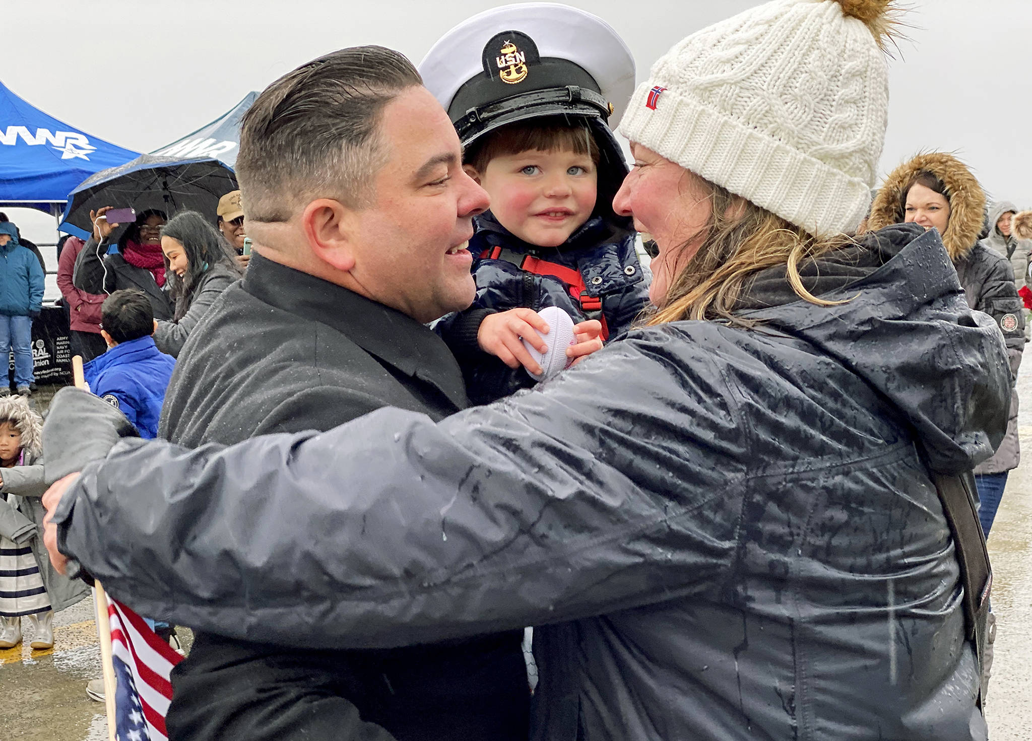 Senior Chief Matthew McFarlane is greeted by his wife, Jessica, and son Max as he disembarks from the USS Gridley on Tuesday morning at Naval Station Everett. (Sue Misao / The Herald)