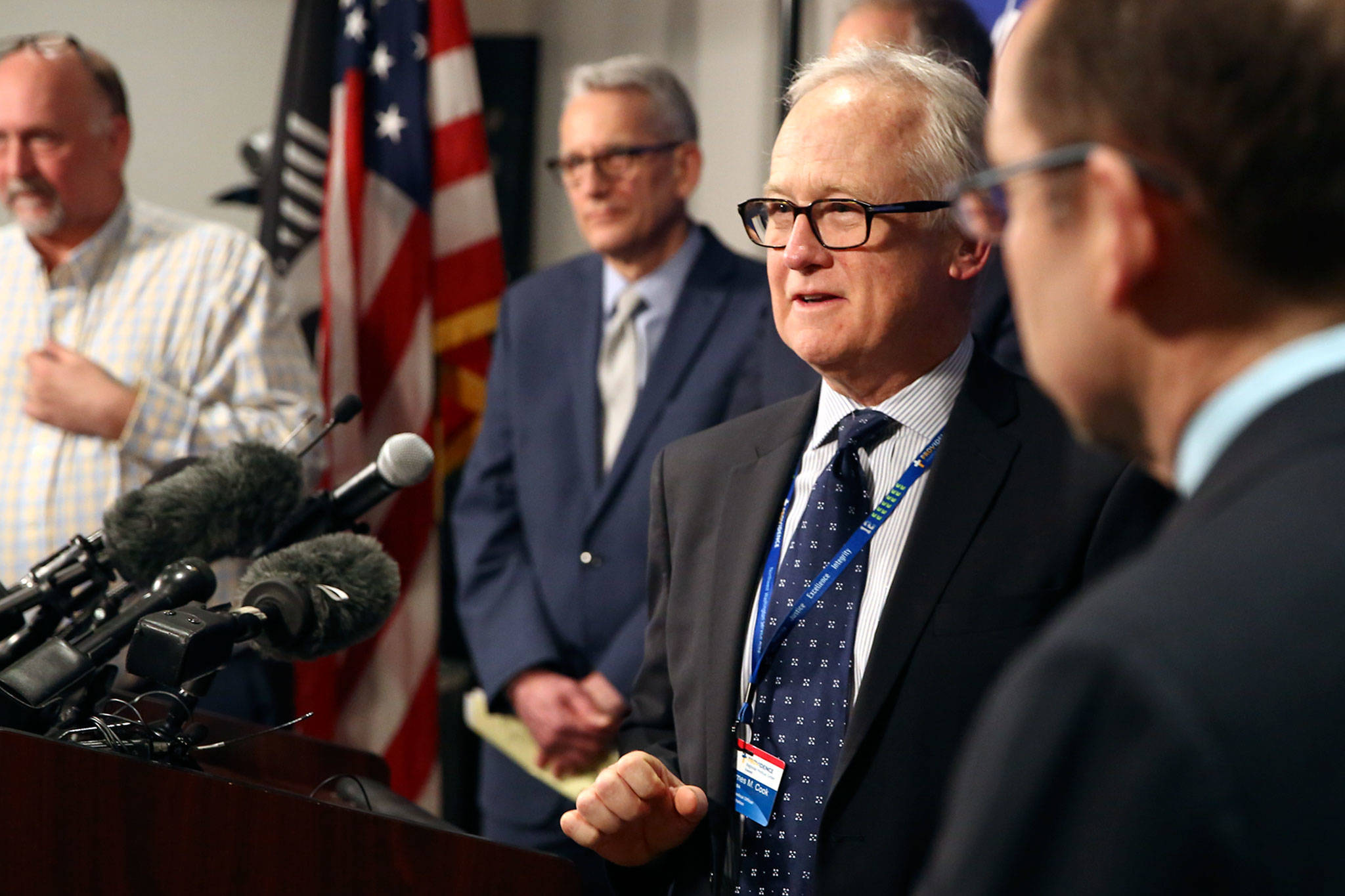 Dr. Jay Cook (second from right), chief of surgery at Providence Regional Medical Center Everett, fields questions during a news conference Tuesday at the state Public Health Laboratories in Shoreline. (Kevin Clark / The Herald)