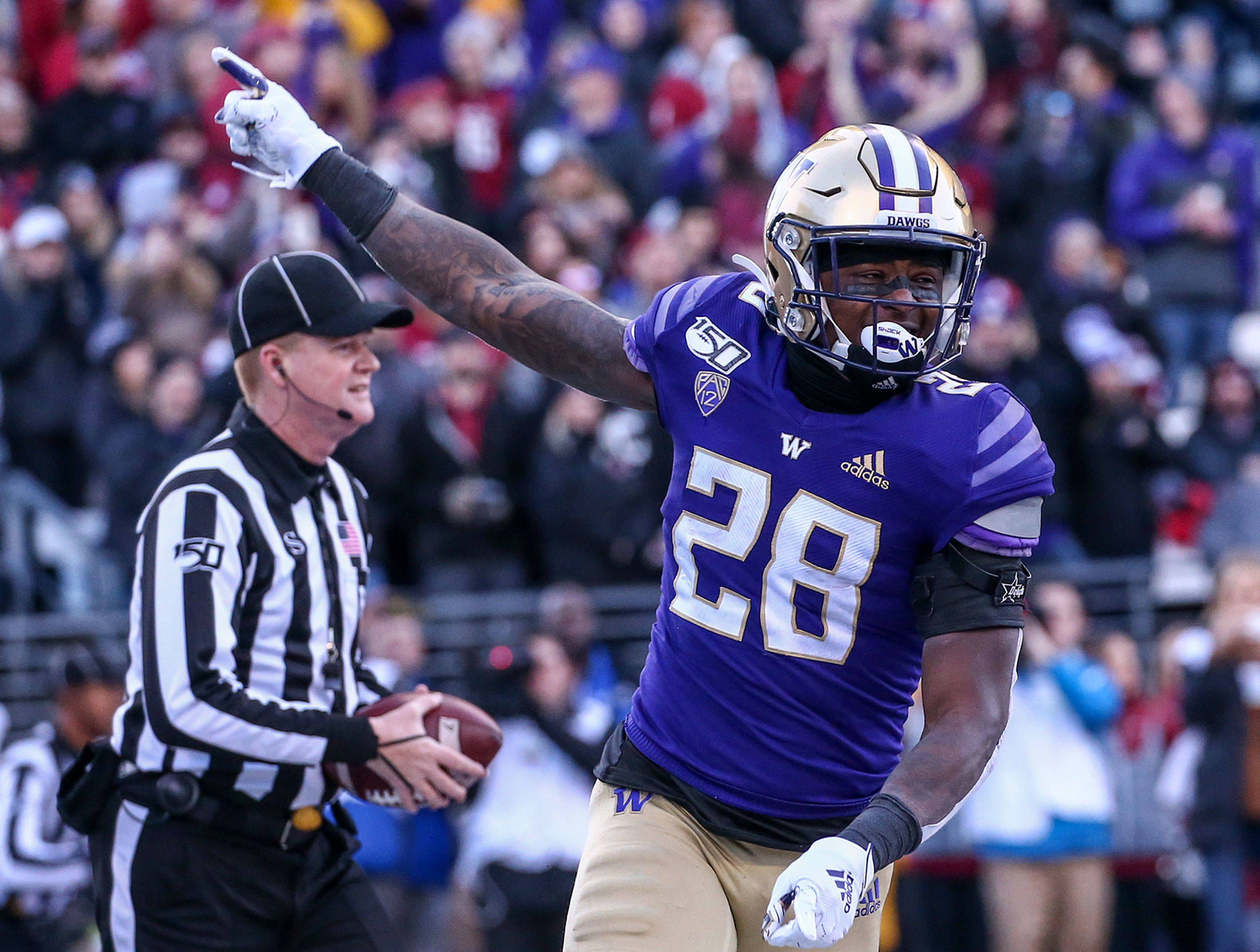 Washington running back Richard Newton (28) celebrates his touchdown during the 112th Apple Cup against Washington State on Nov. 29, 2019, at Husky Stadium in Seattle. (Kevin Clark / The Herald)