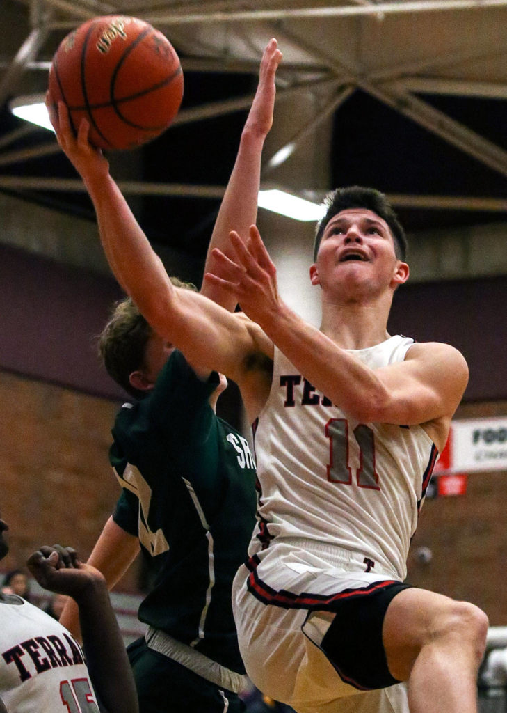 Mountlake Terrace’s Mason Christianson attempts a layup with Shorecrest’s Hayden Bohag defending Wednesday evening at Mountlake Terrace High School in Mountlake Terrace on January 22, 2019. (Kevin Clark / The Herald)
