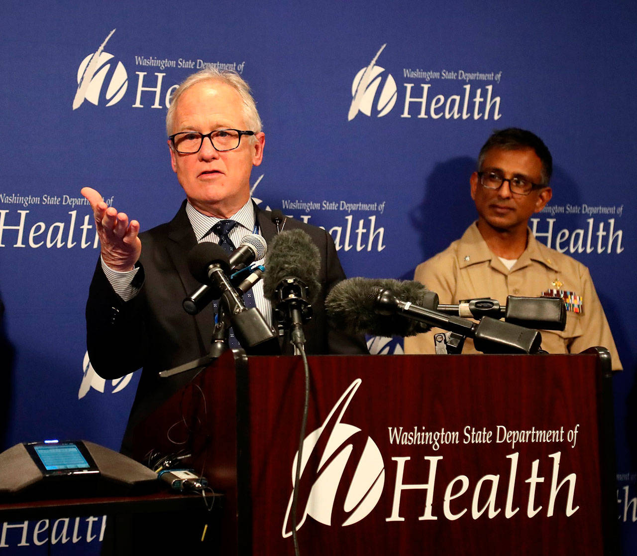 Dr. Jay Cook, with Providence Regional Medical Center Everett, speaks at a news conference at Washington state’s Department of Health Public Health Laboratories, Tuesday, in Shoreline, while speaking on the condition of a patient who is in good condition with the coronavirus. At right is Dr. Satish Pillai, of the Centers for Disease Control and Prevention, in Atlanta. (Greg Gilbert / The Seattle Times)