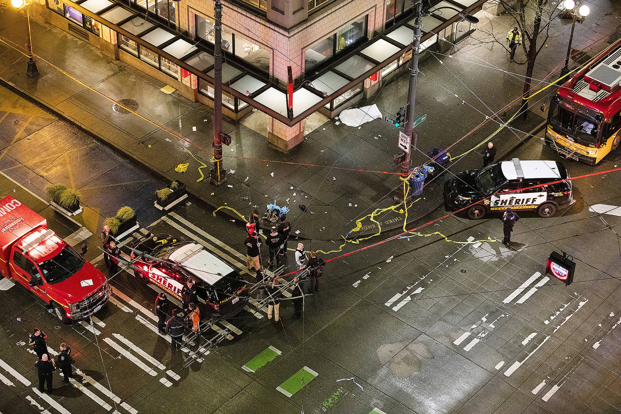 Police work a crime scene after a shooting near 3rd Avenue and Pine Street in downtown Seattle on Wednesday. (Amanda Snyder/The Seattle Times via AP)