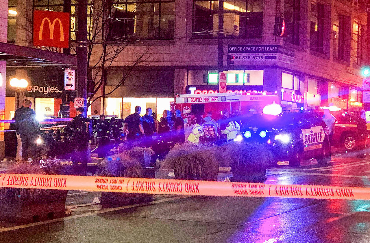 Police work the scene of a shooting on Third Avenue and Pine Street on Wednesday in Seattle. (Amanda Snyder/The Seattle Times via AP)