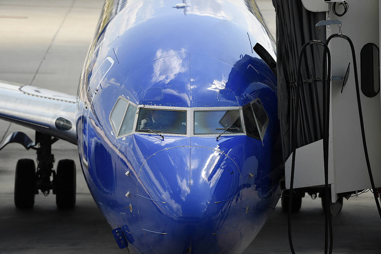 In this 2019 photo, Southwest pilots prepare for a flight at Tampa International Airport in Tampa, Florida. (AP Photo/Mike Stewart, File)