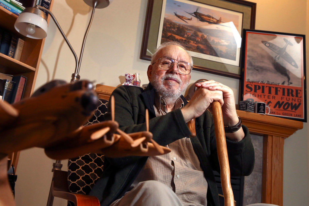 Mike Mancer, 80, of Stanwood, has a portion of his living room dedicated to his father’s service in the British Royal Air Force during World War II. (Kevin Clark / The Herald)
