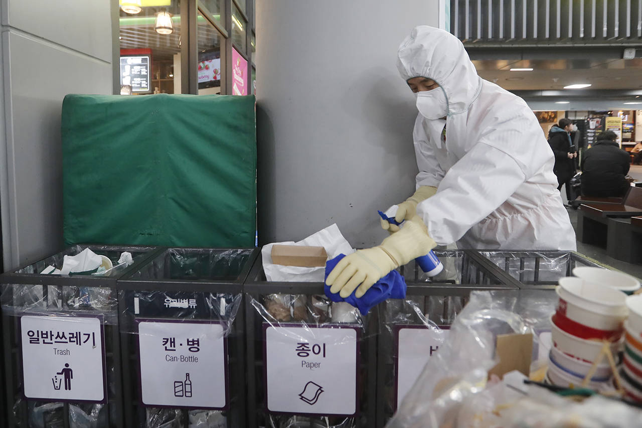 An employee works to prevent a new coronavirus at Suseo Station in Seoul, South Korea, on Friday. (AP Photo/Ahn Young-joon)