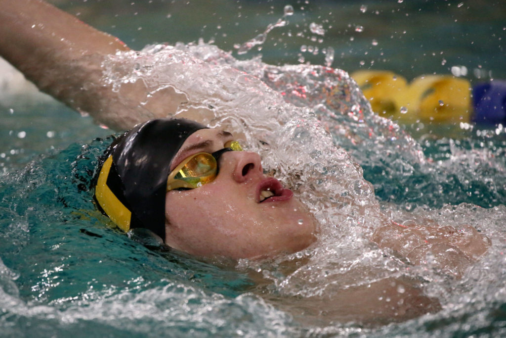 Lake Stevens’ Nathan Fleischmann swims the backstroke leg of the 200 individual medley during a Wesco North meet against Snohomish and Glacier Peak on Thursday at the Snohomish Aquatic Center. Fleischmann won the event iin a time of 2 minutes, 8.9 seconds and helped the Vikings to a pair of wins that put them a step closer to the Wesco North title. (Kevin Clark / The Herald)
