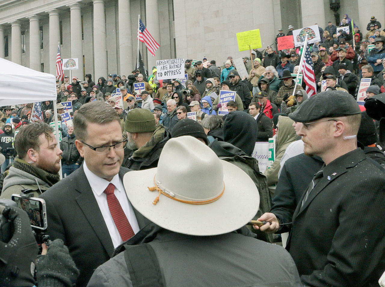 Republican Rep. Matt Shea meets with supporters after speaking at a gun-rights rally Jan. 17 in Olympia. Shea was suspended from the Republican caucus in the wake of a December report that found he was involved in anti-government activities and several lawmakers have called on him to resign. Shea, who says he’s been targeted for his work against anti-gun bills, says he will not resign and will run for re-election this year. (AP Photo/Rachel La Corte)