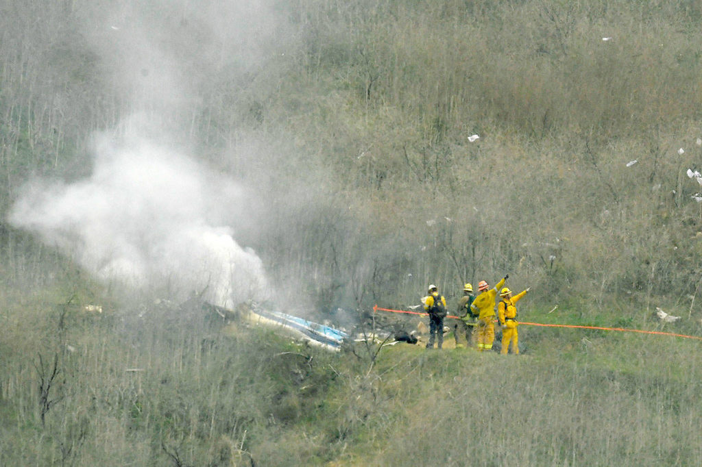 Firefighters work the scene of a helicopter crash where five people, including former NBA star Kobe Bryant, reportedly died Sunday in Calabasas, Calif. (AP Photo/Mark J. Terrill)
