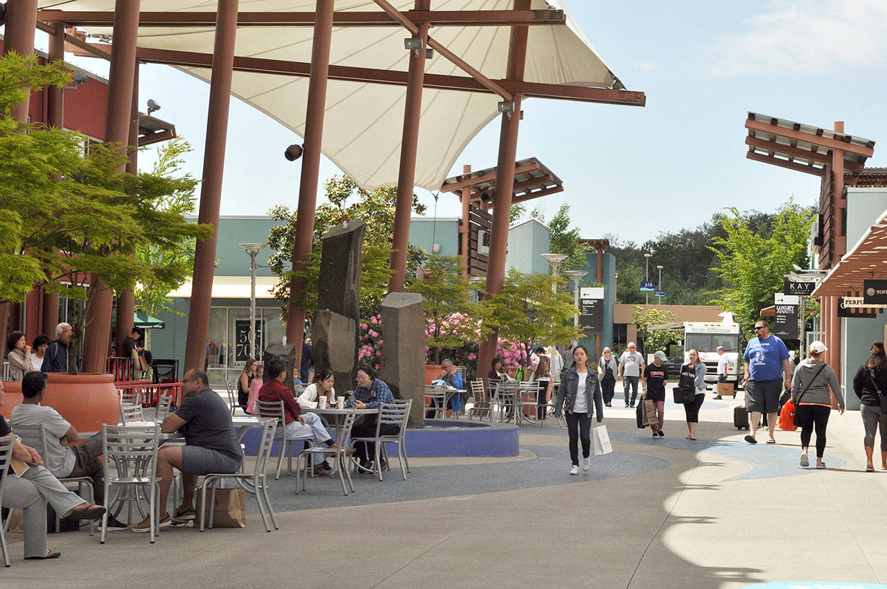 People shop at Seattle Premium Outlets in the Quil Ceda Village in Tulalip. (Sue Misao / Herald file)
