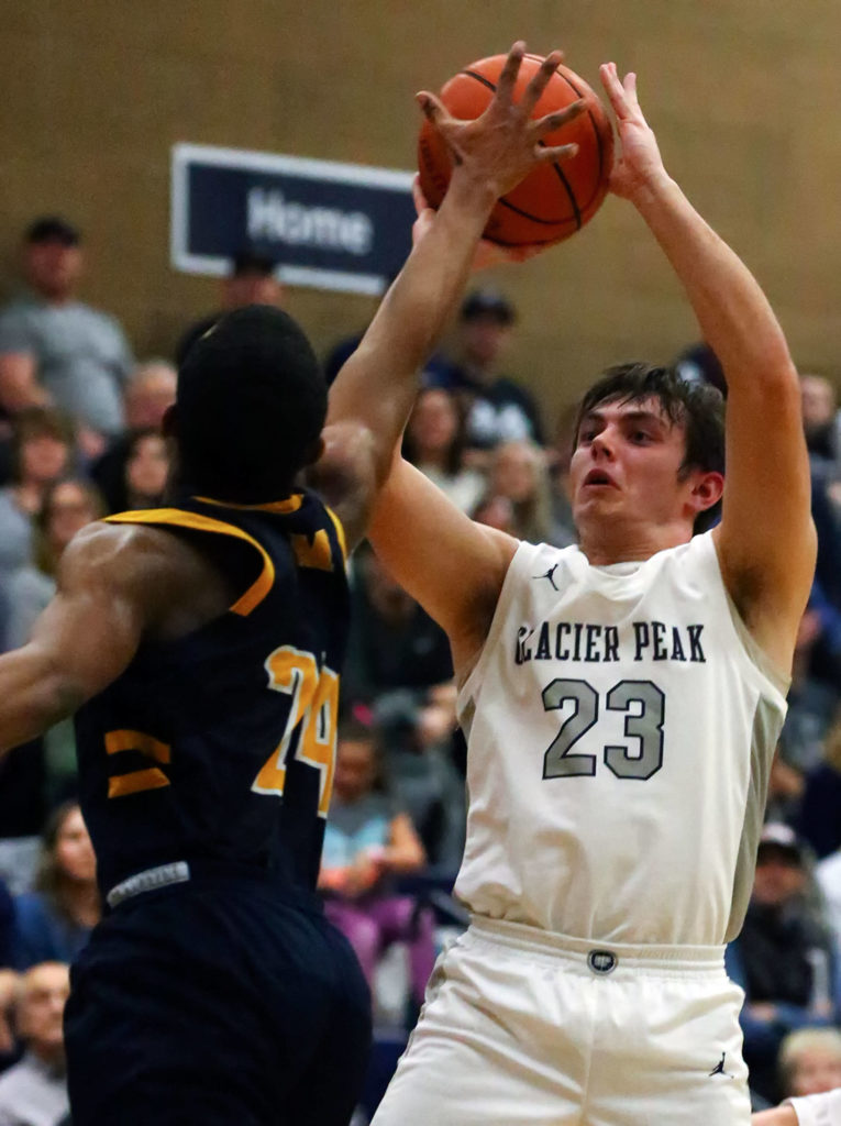 Glacier Peak’s Brayden Corwin shoots over Mariner’s Naser Motley during a Wesco 4A boys basketball game Monday at Glacier Peak High School in Snohomish. Glacier Peak won 55-49. (Kevin Clark / The Herald)
