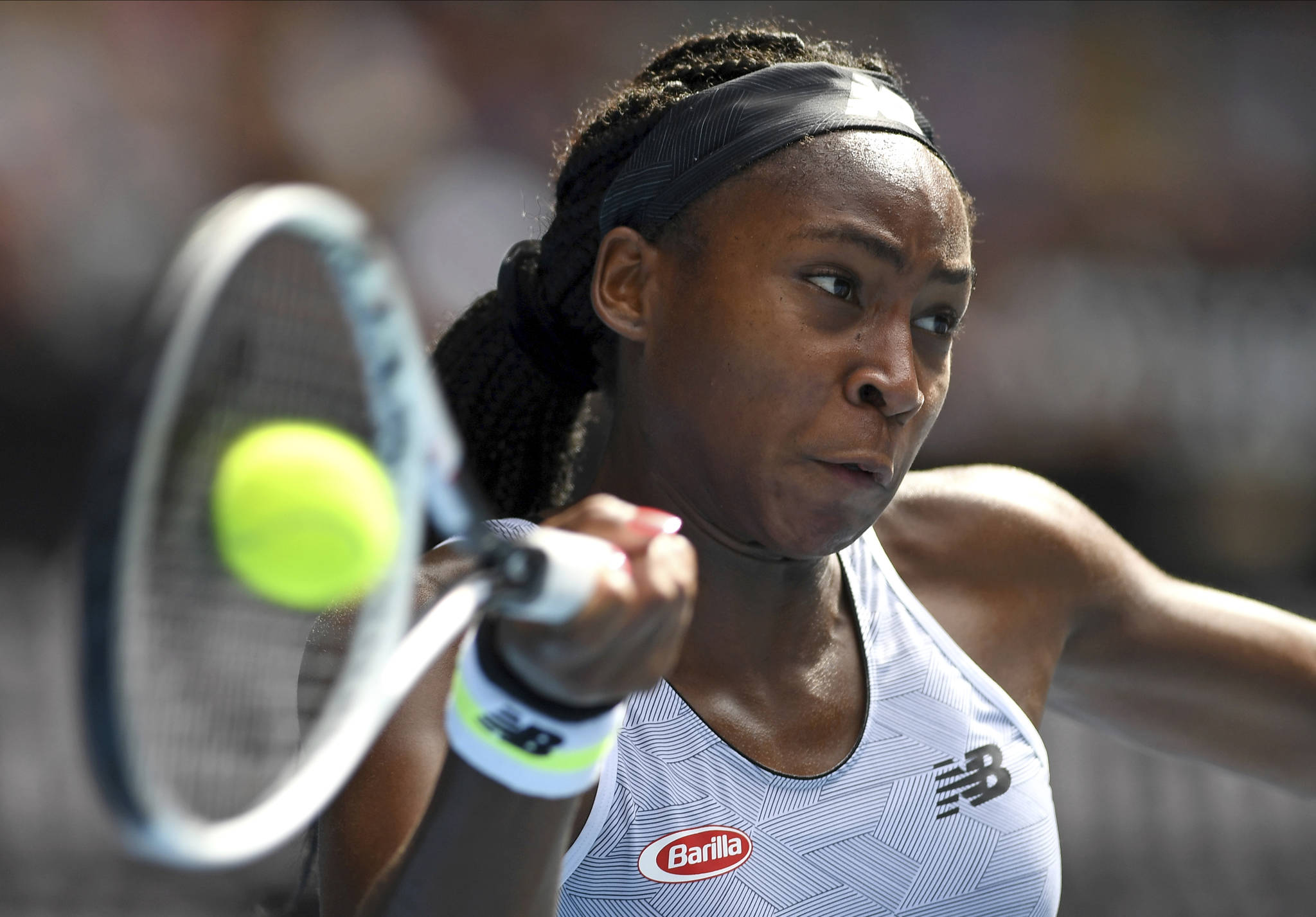 Coco Gauff of the U.S. makes a forehand return to compatriot Sofia Kenin during their fourth-round singles match at the Australian Open on Sunday. (AP Photo/Andy Brownbill)