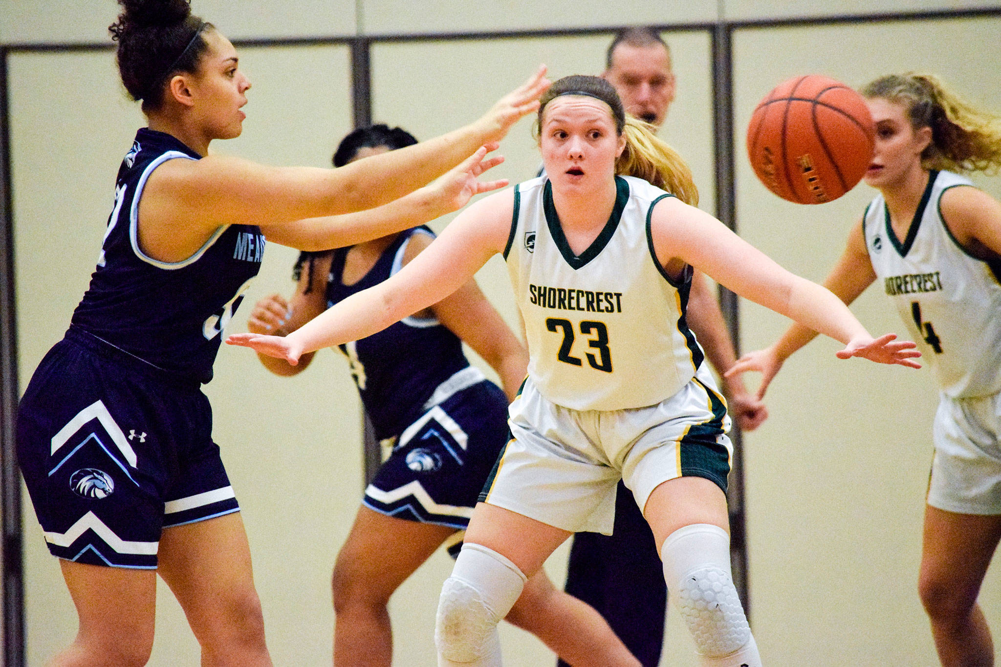 Shorecrest’s Sydney VanNess (23) watches Meadowdale’s Soriah Swinton (left) pass the ball on Thursday at Shorecrest High School in Shoreline. (Katie Webber / The Herald)