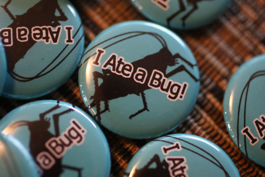 Diners with receive an “I Ate a Bug!” pin after completing David George Gordon’s bug dinner at Darrell’s Tavern. (Kevin Clark / The Herald)
